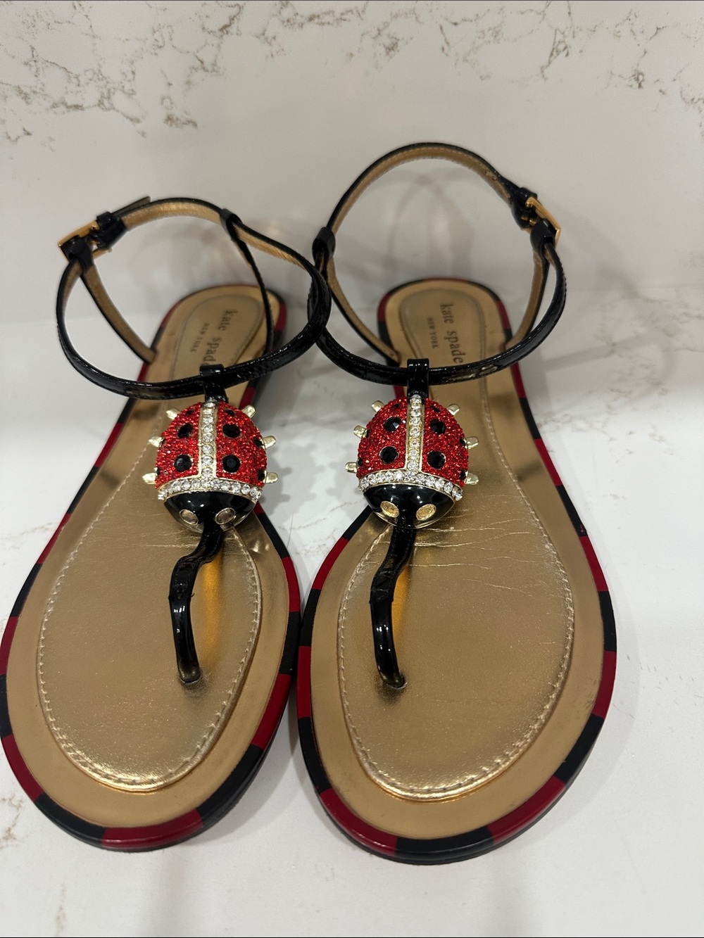 kate spade Black T-Strap Sandals with Red Ladybug Embellishments